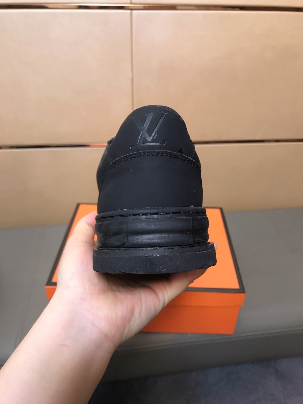 LV TRAINER IN EMBOSSED BLACK SUEDE