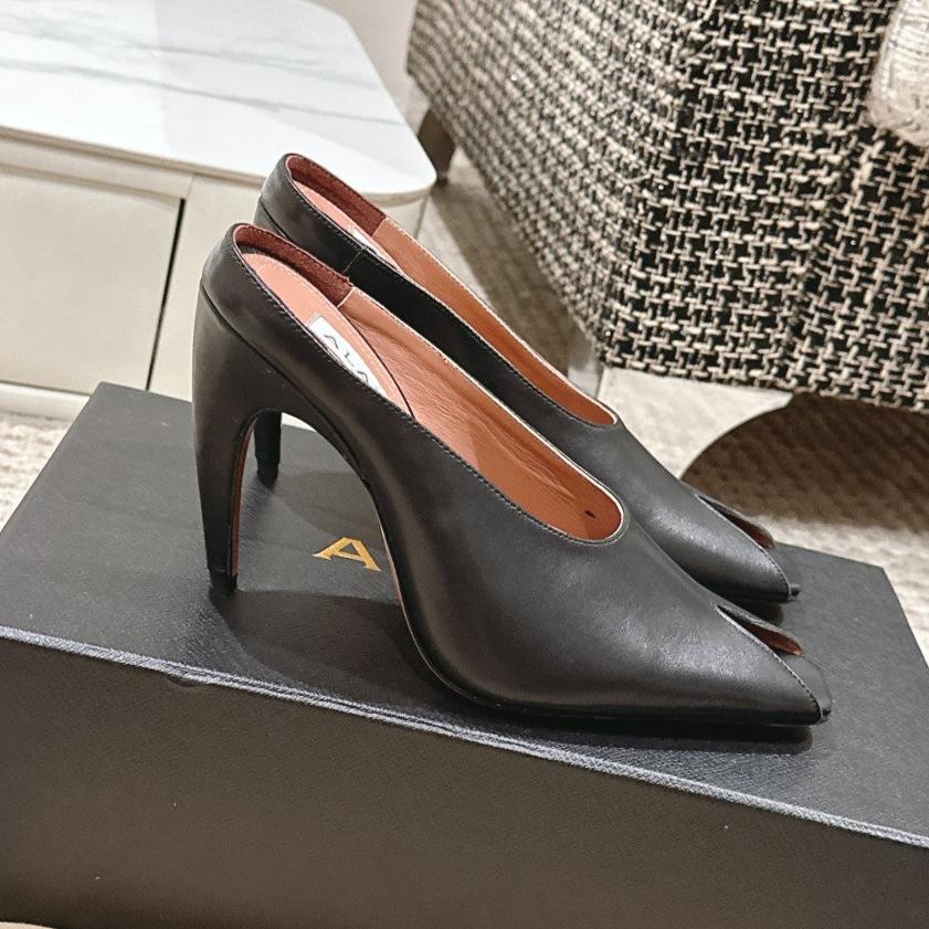 ALAIA SPIKE JEWEL MULES IN BLACK CALFSKIN