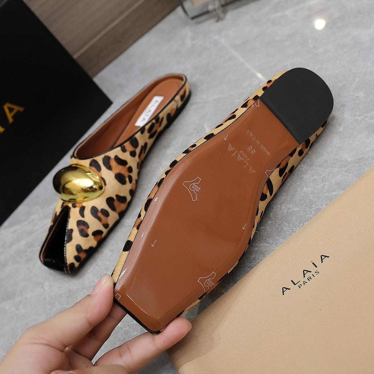 ALAIA FLAT MULE IN LEOPARD LAMBSKIN WITH GOLD HARDWARE