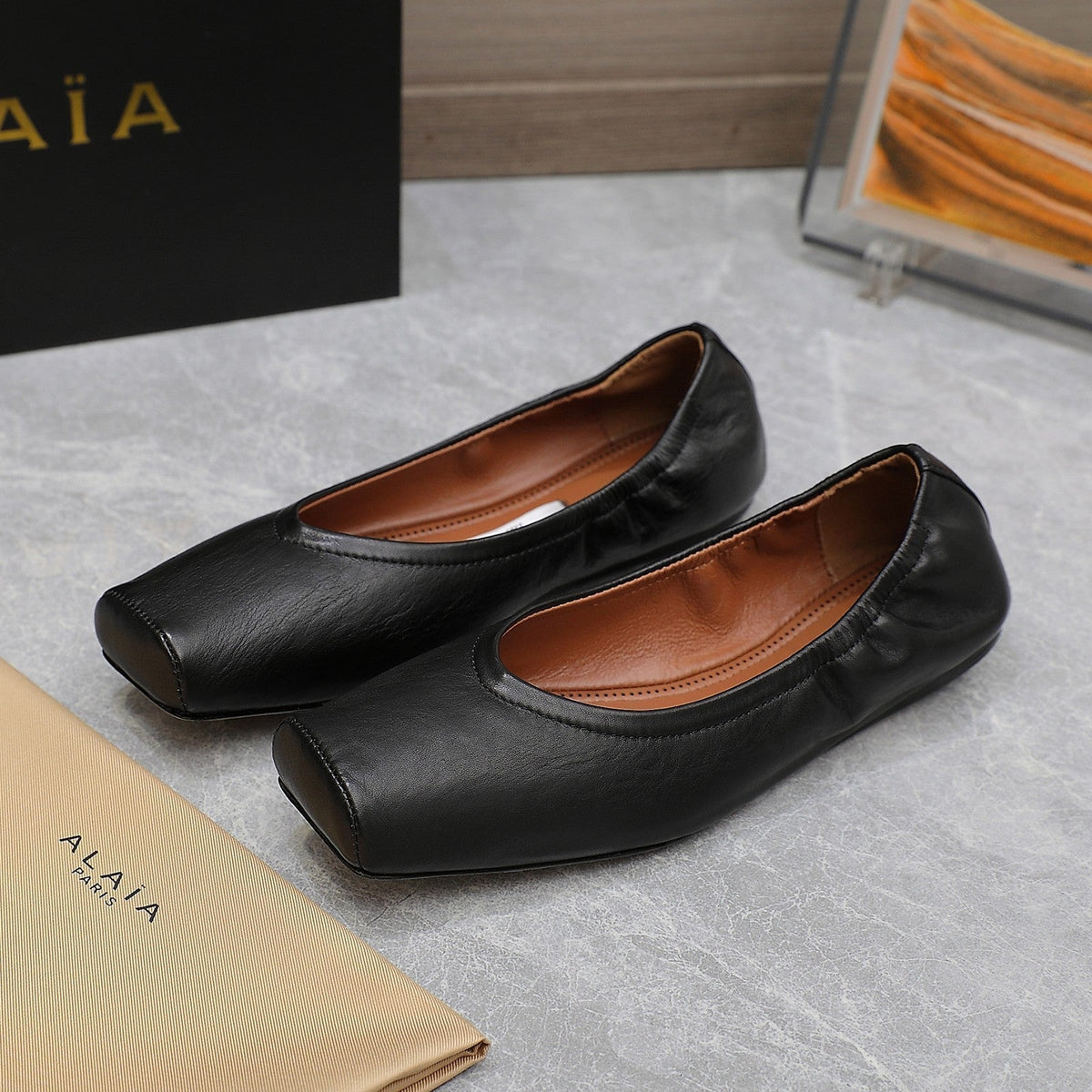 ALAIA BALLET FLATS IN BLACK SMOOTH CALFSKIN