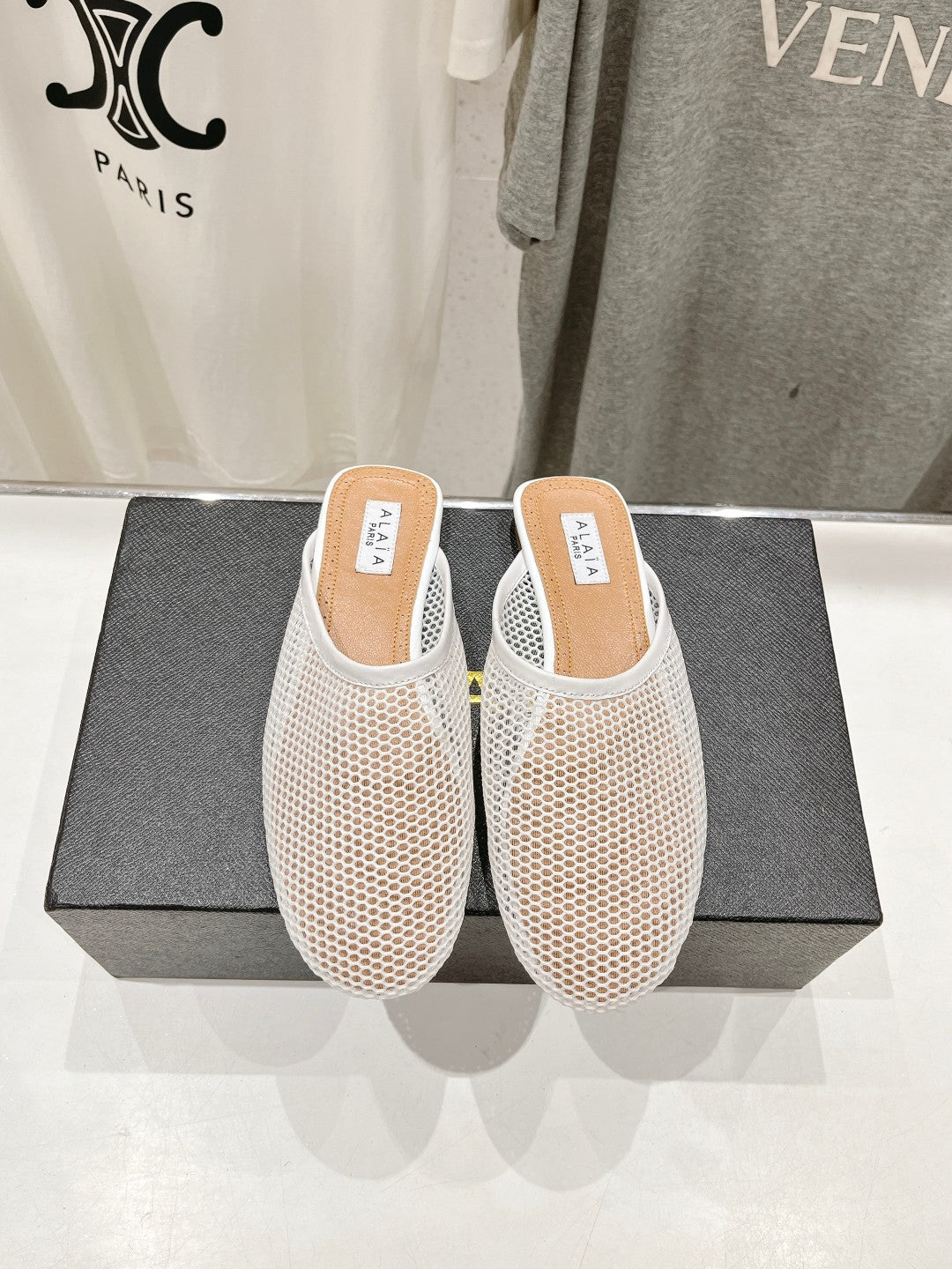 ALAIA FLAT MULES IN WHITE MESH FISHNET