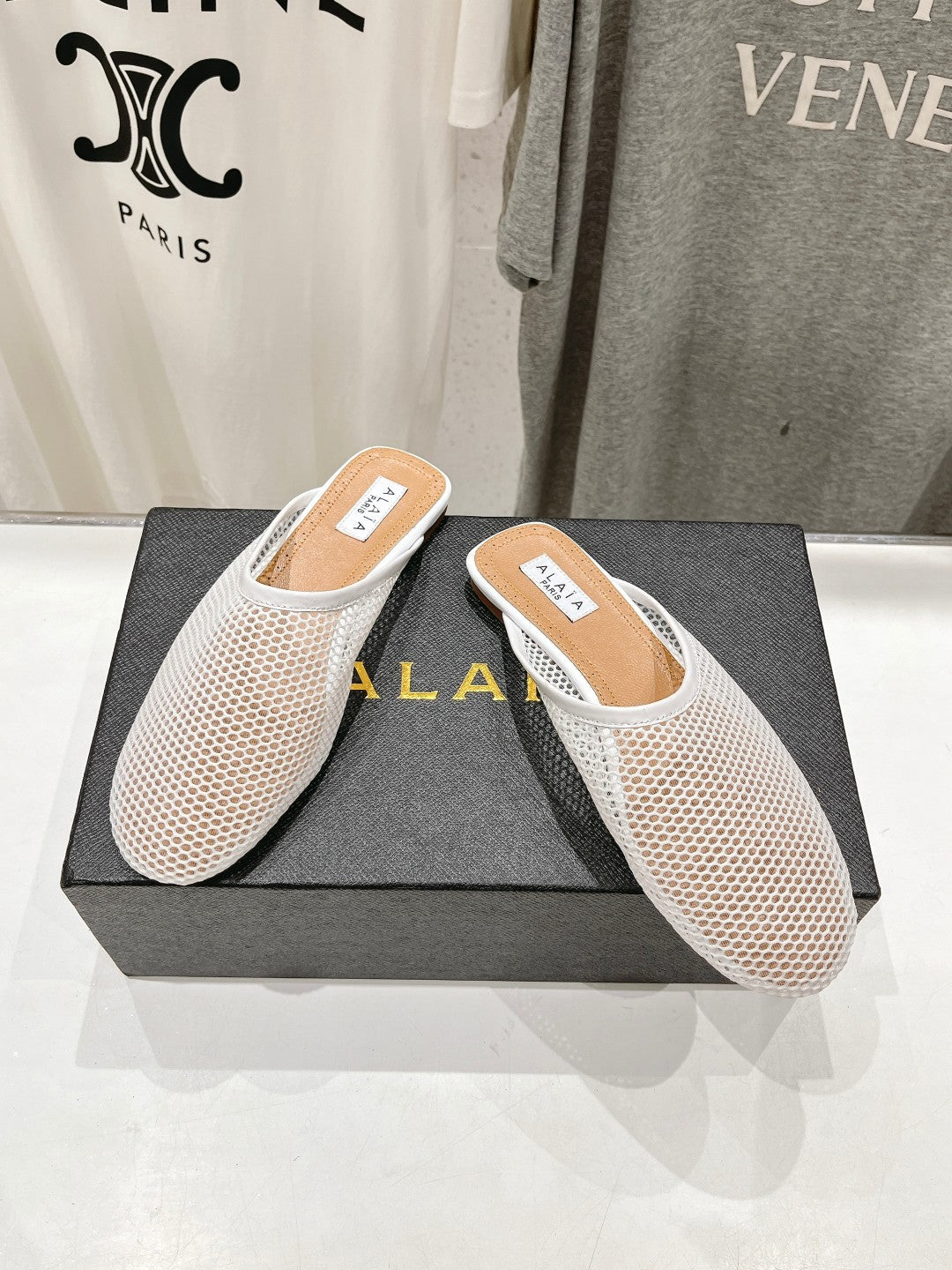 ALAIA FLAT MULES IN WHITE MESH FISHNET